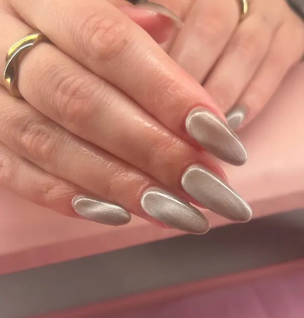 Long almond nails in a champagne taupe velvet finish with a shimmering cat-eye band