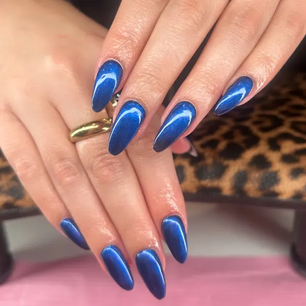 Long almond nails in deep navy blue with a velvet cat-eye shimmer