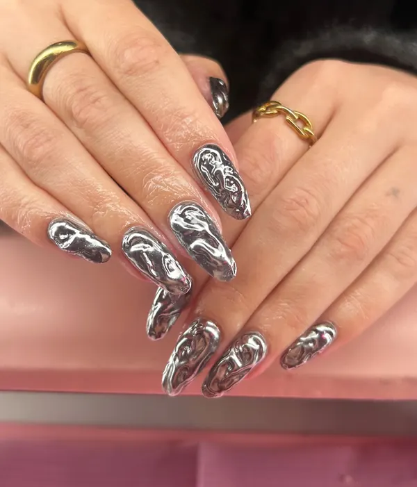 Long almond nails in raised, molten-effect silver chrome
